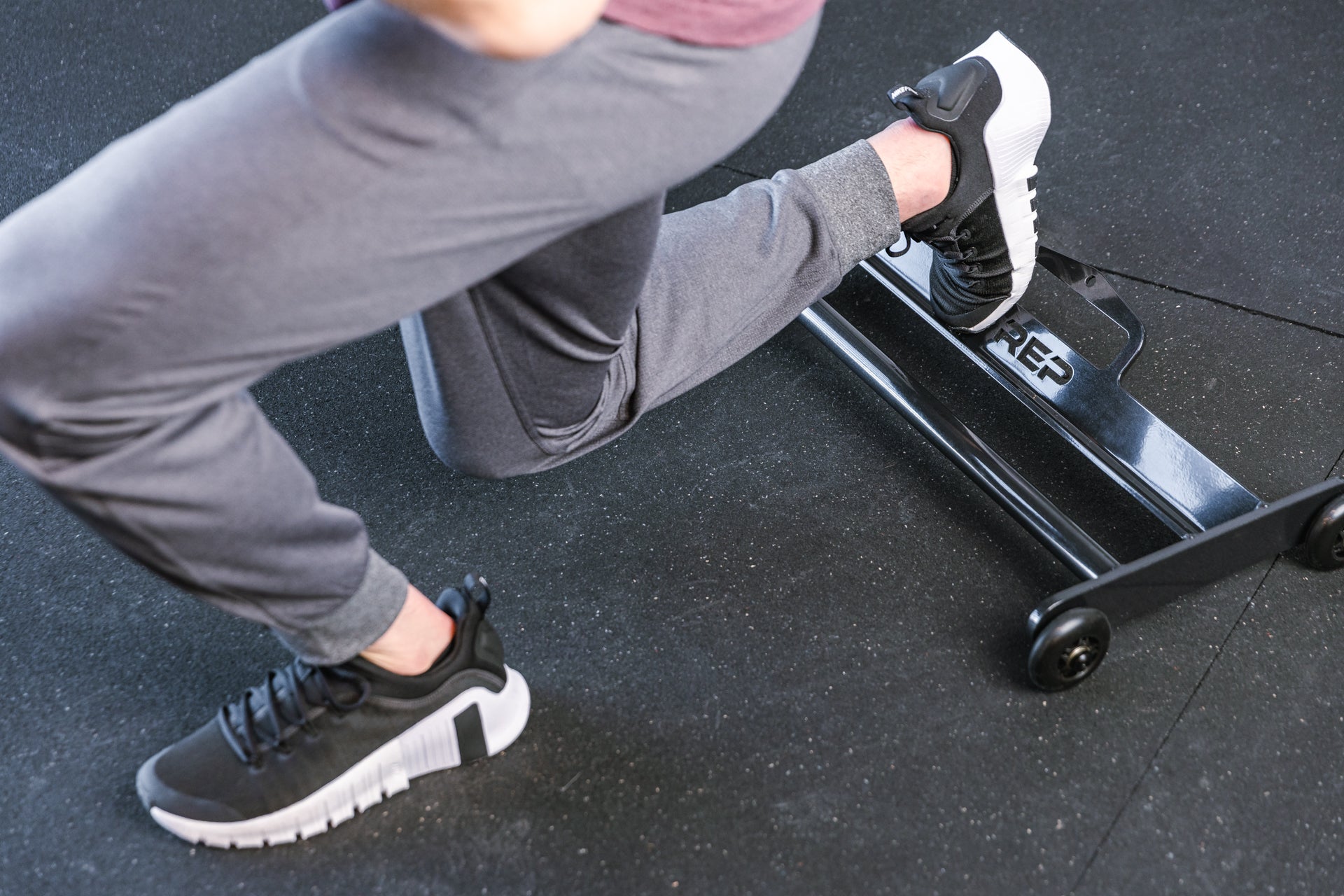 Athlete with 1 foot on the glute ham roller